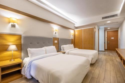 a hotel room with two beds and a television at Weston Suites Hotel in Santo Domingo