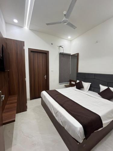 a bedroom with a large bed and a tv at Hotel Divaa Inn in Mathura