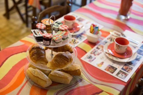 a tray of pastries and cupcakes on a table at Logis hôtel du terreau in Manosque