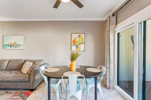 a living room with a table and a couch at Sunkissed Oasis in Navarre