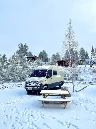 a suv parked in a parking lot in the snow at Offroadcamp Dalarna - Adventure Camping & Cabins in Sörsjön