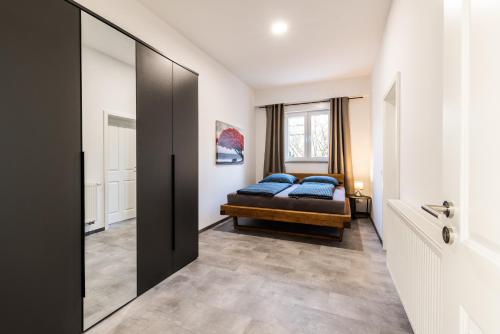 a bedroom with a bed and a mirror at Modernes Apartment in Mistelgau 3 in Mistelgau