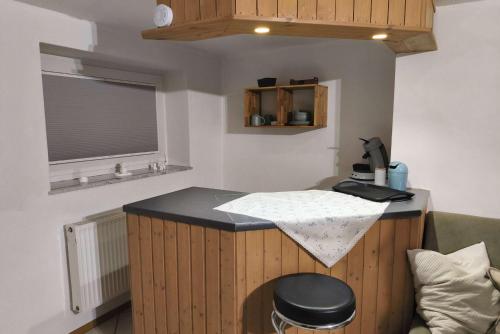 a room with a counter with a stool and a window at Private room with own bathroom in Harsum