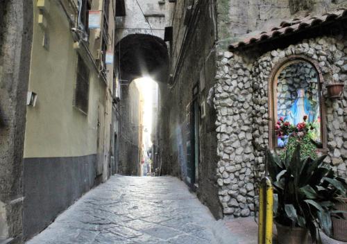 an alley way in an old building with a tunnel at B&B Alloggio Maria in Naples