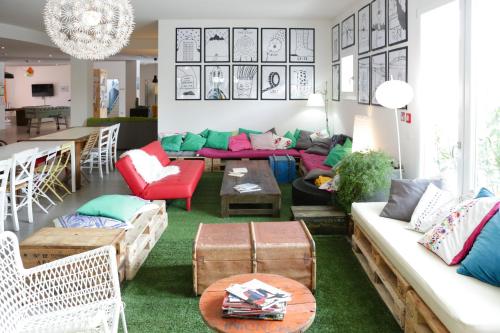 a living room with a couch and a table at Ostello Meet Gardalake Hostel in Peschiera del Garda