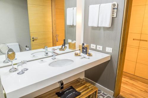 a bathroom with a sink and a mirror at Sonesta Hotel Bogotá in Bogotá