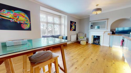 a kitchen and living room with a glass counter top at Stunning 2 Bed Georgian Apartment in North Walsham