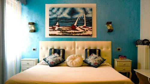 a bedroom with a bed with a painting on the wall at Florivana Boutique Hotel in San Pietro in Cariano