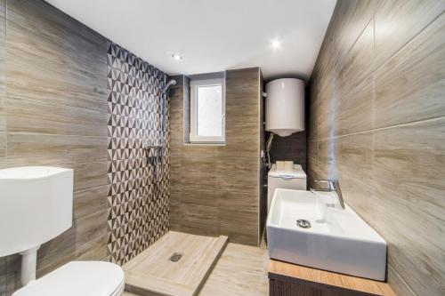 a bathroom with a white sink and a toilet at D53 Apartments in Budapest