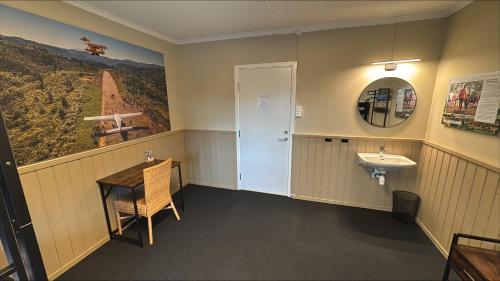 a bathroom with a sink and a mirror and a sink at Stayover Lista in Farsund
