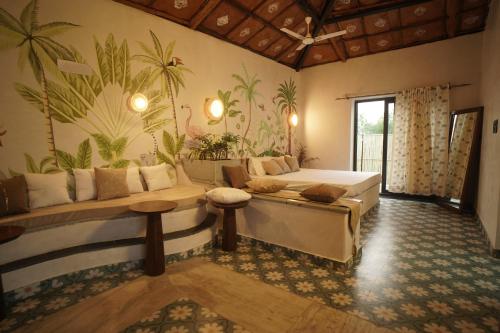 a living room with a couch and a table at Mud & Meadows- A Satvik Farmstay, Jamshedpur in Jamshedpur