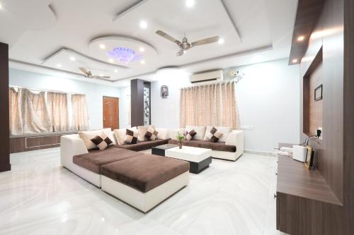 a living room with a couch and a table at Sri Padam HomeStay in Tirupati