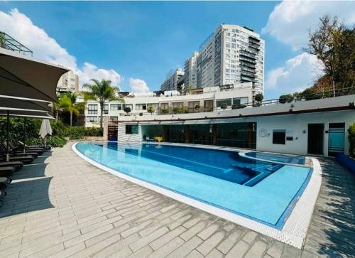 a large swimming pool in front of a building at Amazing pool in the middle of the city in Mexico City