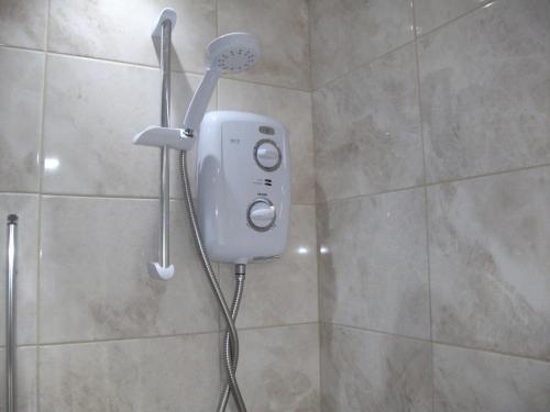 a shower with a blow dryer in a bathroom at The Grange in Middlesbrough