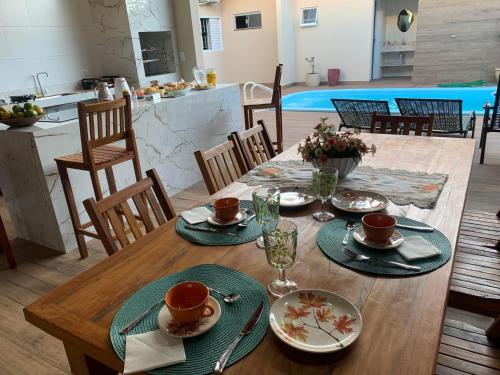 a wooden table with plates of food on it at Pousada Recanto Populina in Populina