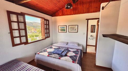 a bedroom with two beds and a window at Amazing house with chalet and a beautiful garden in Sêrro