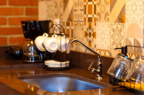 a kitchen counter with a sink and a counter top at ChapadaFlats in Chapada dos Guimarães