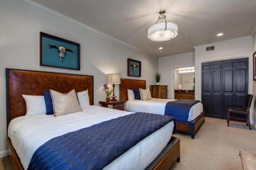 a bedroom with two beds and a bathroom at Abode on Lower Main Street in Park City