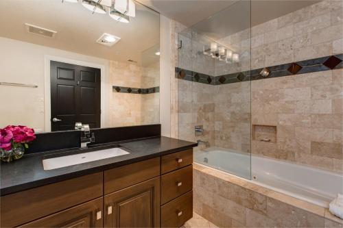 a bathroom with a sink and a bath tub at Abode on Lower Main Street in Park City