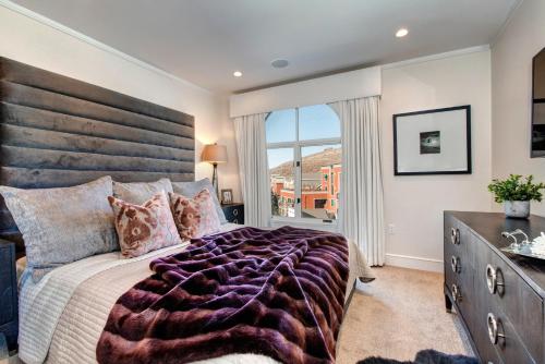 a bedroom with a large bed and a large window at Abode at Sky Silver Edge in Park City