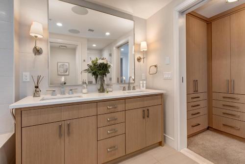 a bathroom with two sinks and a large mirror at Abode at Sky Silver Edge in Park City