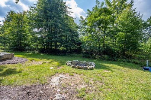 a yard with a pile of rocks in the grass at The Hygge Chalet by Railey Vacations in McHenry