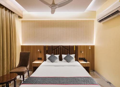 a bedroom with a bed and a desk and chairs at Hotel Dream Patna in Patna