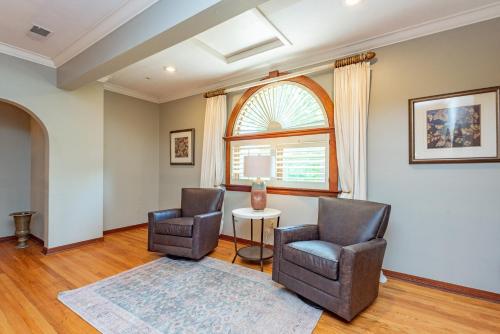 a living room with two chairs and a table at The Herrington by Railey Vacations in Oakland