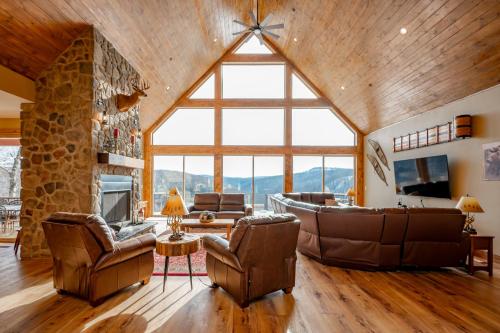 a living room with a couch and chairs and a fireplace at Bear Cliff Lodge by Railey Vacations in Friendsville