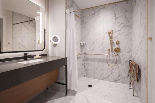 ein Badezimmer mit Dusche, Waschbecken und Badewanne in der Unterkunft Caesars Virginia Hotel & Casino - A Caesars Rewards Destination in Danville