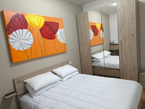 a bedroom with a white bed and a mirror at Zuretti House in Milan