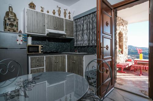 a kitchen with a table and a counter top at Irini Studios in Psarou