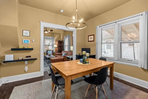 a dining room with a wooden table and chairs at Cairo St Bungalow in Springfield
