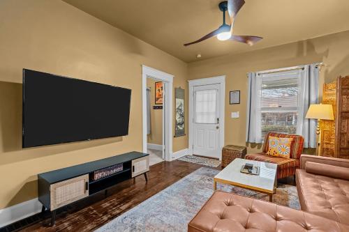 a living room with a flat screen tv on the wall at Cairo St Bungalow in Springfield