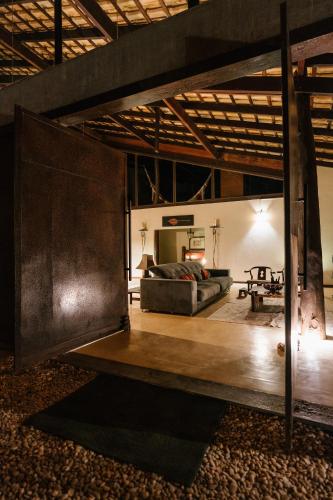 a large room with a bed and a table at Casa da Mata - Sao Jorge GO in Sao Jorge