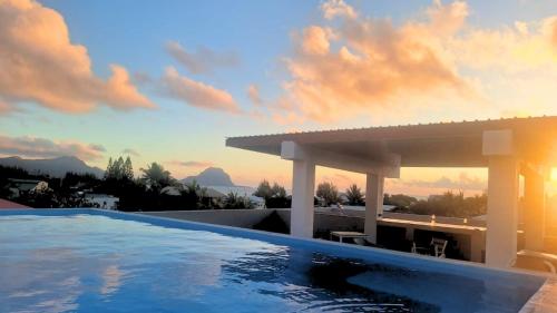 a swimming pool on the roof of a house at Sunset Corner in Rivière Noire