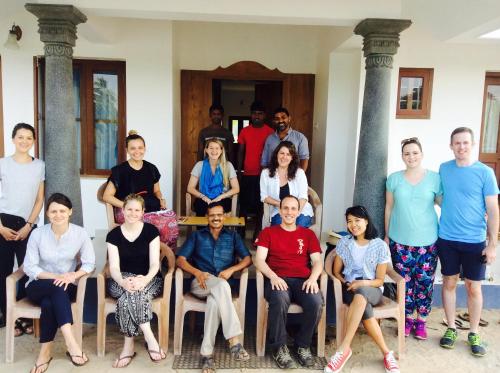 a group of people posing for a picture in a house at Ayana's Homestay in Alleppey