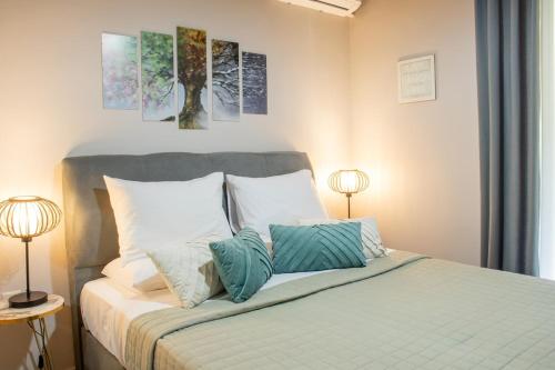 a bedroom with a bed with pillows and two lamps at Cozy Spot in Ixia