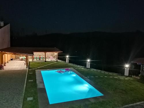 a swimming pool in the yard at night at Eucalyptus Pink House in Covelo