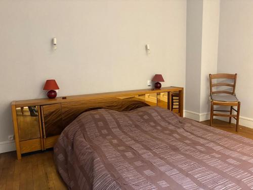 a bedroom with a bed and a desk and a chair at Mélusine - logement tout confort in Parthenay