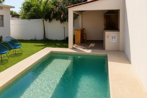 a swimming pool in the backyard of a house at Casa Maya, tu escape con alberca privada in Puerto Escondido
