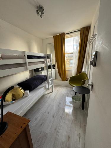 a bedroom with bunk beds and a desk and a chair at Rooms in Islington in London