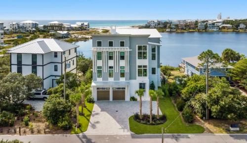 an aerial view of a large white house with a street at 283 Lakeview Drive in Seagrove Beach