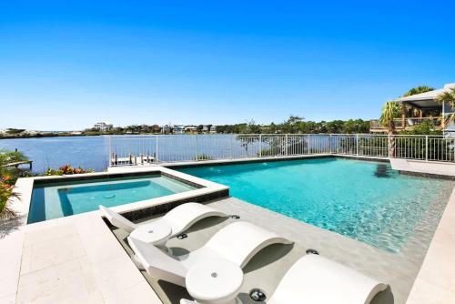 a swimming pool with chairs and a view of the water at 283 Lakeview Drive in Seagrove Beach