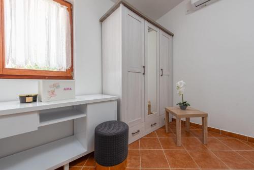 a room with a white cabinet and a table at Holiday home Atrium in Nin