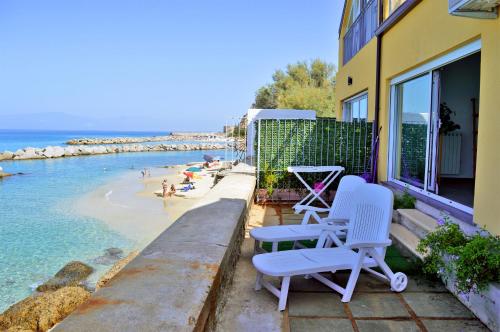 a balcony with two chairs and a beach at Marina Holiday Home in Pizzo
