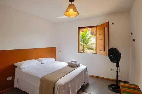 a bedroom with a large white bed and a window at Casa Brisa do Vale - Ar condicionado nos 2/4 .. in Lençóis
