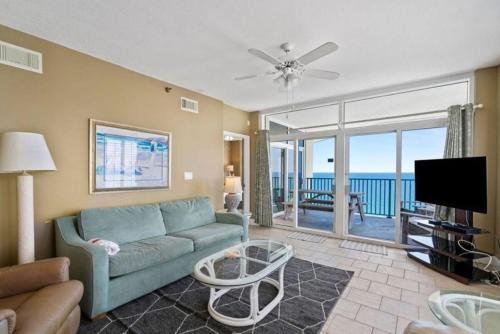 a living room with a blue couch and a television at Jade East Towers 1850 in Destin