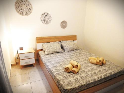 a bedroom with a bed with two teddy bears on it at Eva's Eden in Vourvourou