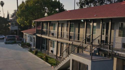 a building with a red roof and balconies on it at Jewel City Inn in Glendale